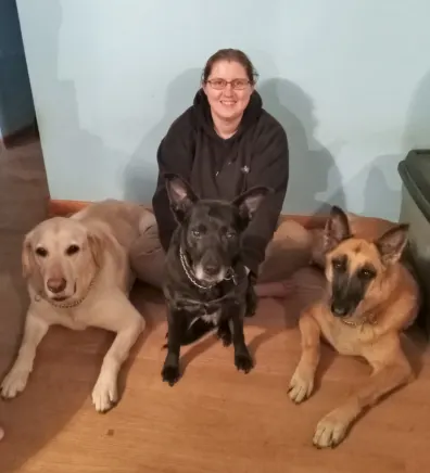 Kristina, trainer at No Leash Needed Rock Hill, with three dogs